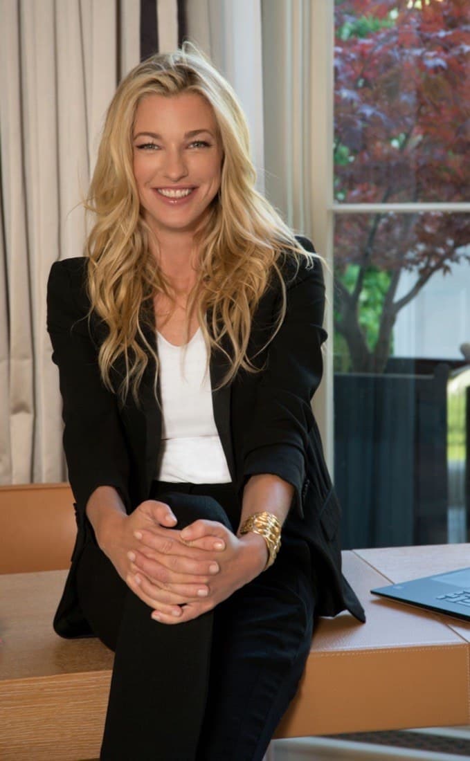 Nicole Junkerman smiling warmly while seated by a window